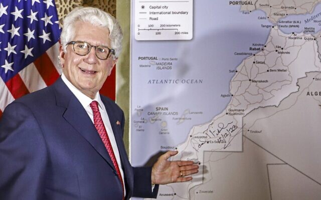 David T. Fischer, US Ambassador to the Kingdom of Morocco, standing before a US State Department-authorised map of Morocco recognising the internationally-disputed territory of the Western Sahara (bearing a signature by Fischer) as a part of the North African kingdom, in Morocco's capital Rabat on December 12, 2020. (Photo by - / AFP)