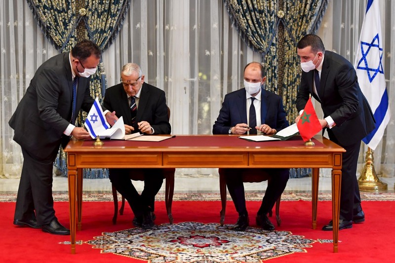 Representatives of Israel and Morocco sign an agreement at the Royal Palace in the Moroccan capital Rabat on December 22, 2020, on the first Israel-Morocco direct commercial flight, marking the latest US-brokered diplomatic normalisation deal between the Jewish state and an Arab country. (Photo by FADEL SENNA / AFP)