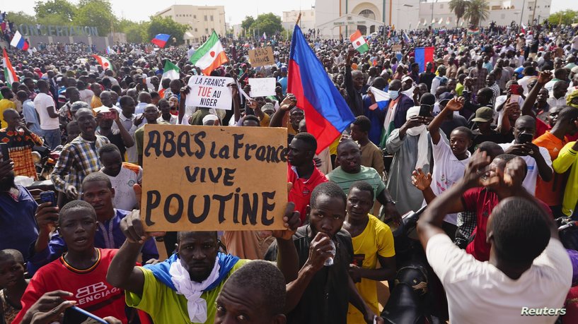 Nigeriens participate in a march called by supporters of coup leader Gen. Abdourahmane Tchiani in Niamey, Niger, Sunday, July 30, 2023. Days after mutinous soldiers ousted Niger's democratically elected president, uncertainty is mounting about the country's future and some are calling out the junta's reasons for seizing control. The sign reads: "Down with France, long live Putin." (AP Photo/Sam Mednick)