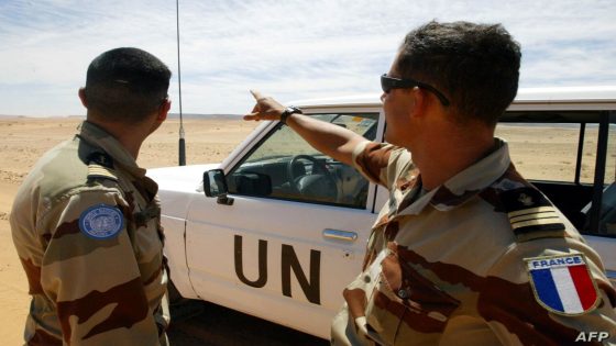 French soldiers of the United Nations mission for the organization of a referendum in Western Sahara (MINURSO) watch an almost desert landscape as they stand near their vehicle at the Oum Dreyga observation site, 450 kms south of El Ayoun, the region's main city, 09 May 2004. The Oum Dreyga observation site is one out of nine military sites set up by the MINURSO in 1991, in charge of monitoring a ceasefire reached by Morocco and the Western Sahara's Polisario Front the same year, and one out of four sites on the Moroccan side of a huge, fortified 2,000-kilometer-long sand wall built by the Moroccan army from 1982 to put an end to the Polisario Front's deadly raids. The Polisario Front is a rebel movement backed by Algeria in its fight for independence from Morocco of the former Spanish colony. AFP/PHOTO/ABDELHAK SENNA / AFP PHOTO / ABDELHAK SENNA